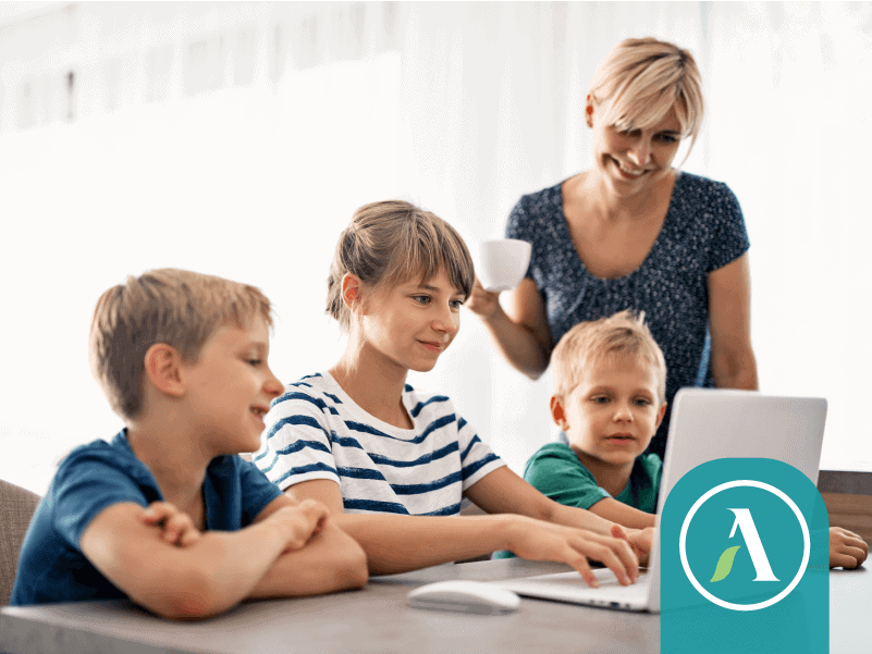 Mom and kids at computer.