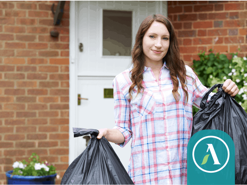 Girl holding garbage bag