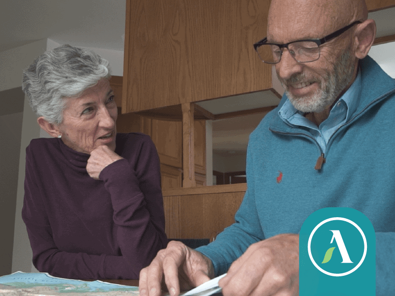 Wendy and Gordon make plans at table with a map.